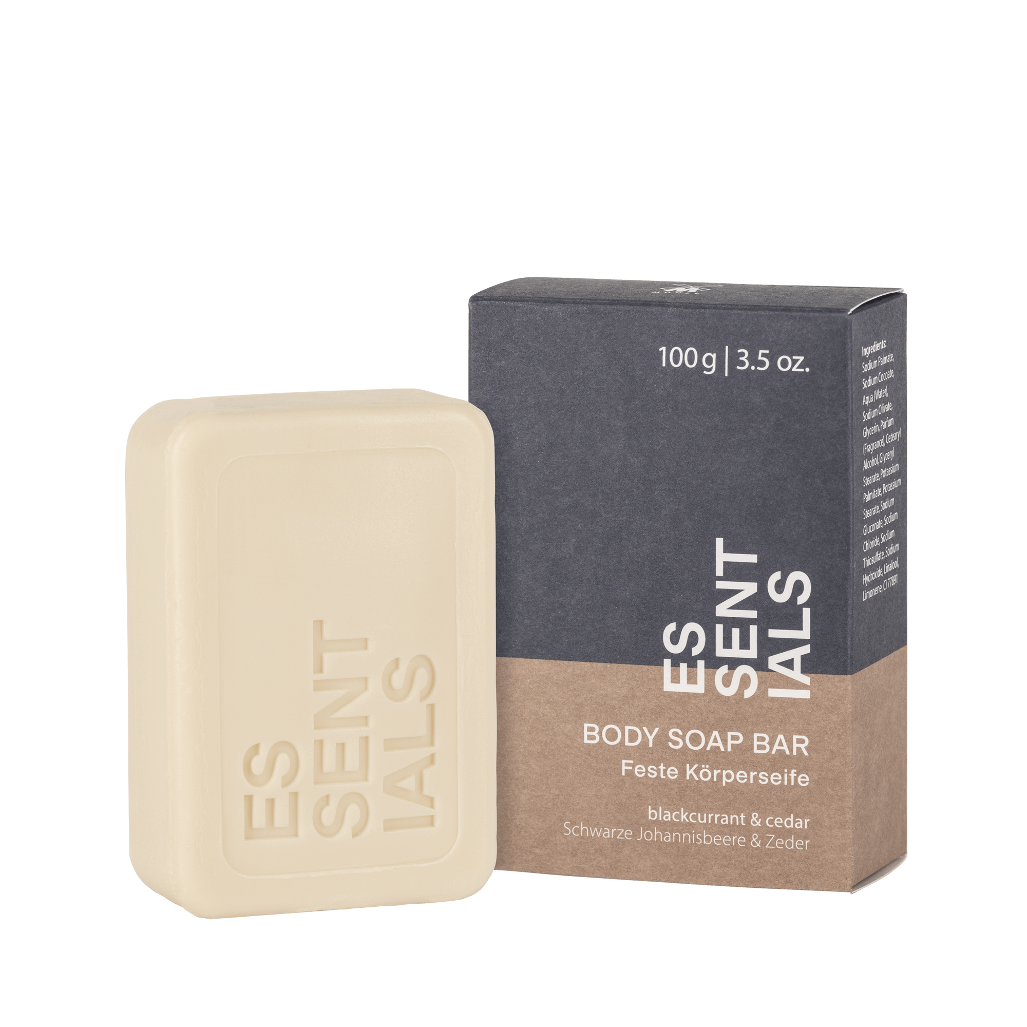 Verpackung und feste Körperseife der Marke Essentials in Grau und Braun. Die Seife mit dem Schriftzug "ESSENTIALS" duftet nach Schwarzer Johannisbeere und Zeder.